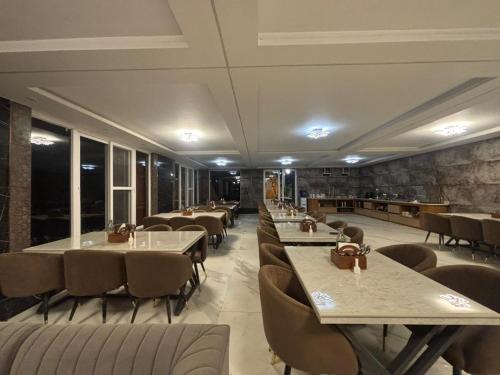 a dining room with tables and chairs in a restaurant at Muskan Mount View Retreat, Mukteshwar in Mukteswar