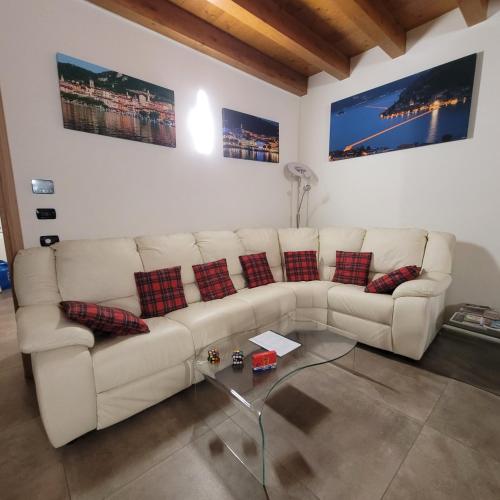 a living room with a white couch and a glass table at Eva Lake Endine Hospitality in Endine Gaiano