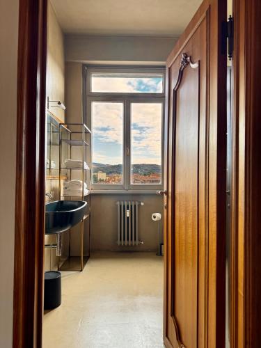 a bathroom with a sink and a window at Terrazza sul Duomo in Arezzo