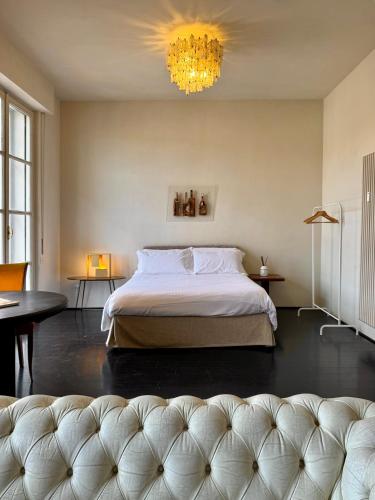 a bedroom with a large bed and a chandelier at Terrazza sul Duomo in Arezzo