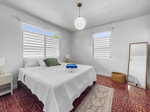 a bedroom with a bed with a blue stool on it at Marley n Enzos Surf Shack in Aguadilla