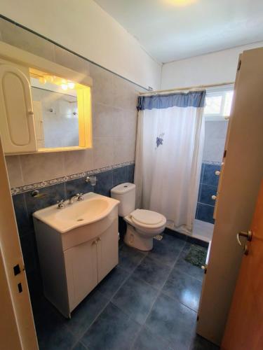 a bathroom with a sink and a toilet and a mirror at Hotel Ritz in Villa Carlos Paz