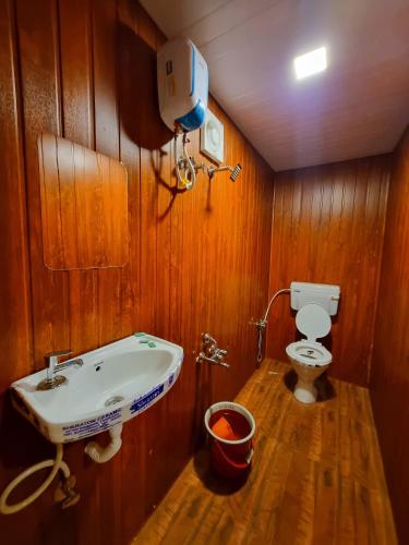 a bathroom with a sink and a toilet at Pawan leke cottage in Kolvan