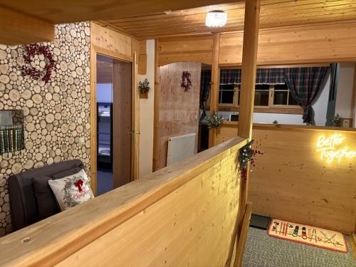 a room with a wooden railing in a room at Hirzhof SO Bike&Ski Ridehaus Ski In Ski Out in Auberg