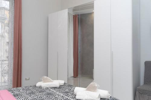 a bedroom with a bed with white towels on it at PORTACAPUANA Guest House in Naples