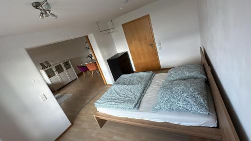 a bedroom with a large bed with blue sheets at Monteur und Ferienwohnung nahe Ulm Zentrum, Legoland Deutschland 