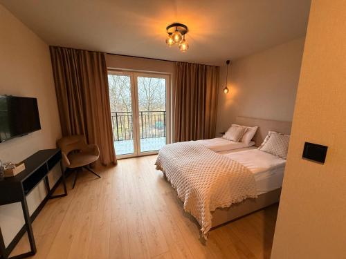 Ένα ή περισσότερα κρεβάτια σε δωμάτιο στο Zajazd Kasztelański