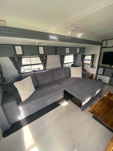 a living room with a couch and a table at Clamping Caravan in Whanganui