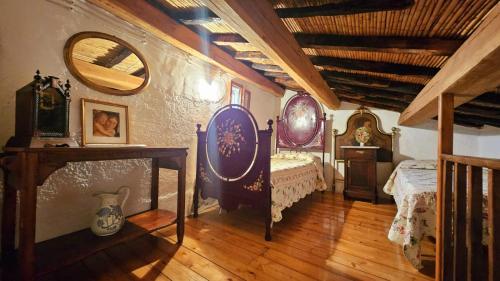 a bedroom with two beds and a mirror on the wall at B&B Montiju in Ozieri