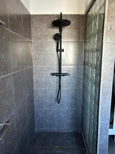 a shower with a shower head in a bathroom at appartement Topaze in Essaouira
