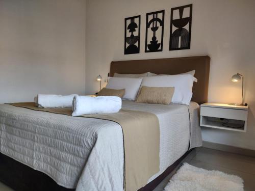 a bedroom with a large bed with two pillows on it at "REFUGIO EN LA TERRAZA" - WiFi 300mbs in Santiago del Estero