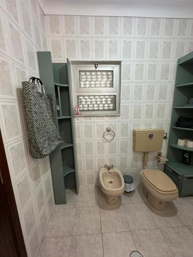 a small bathroom with a toilet and a window at Bem estar 3 in Chaves