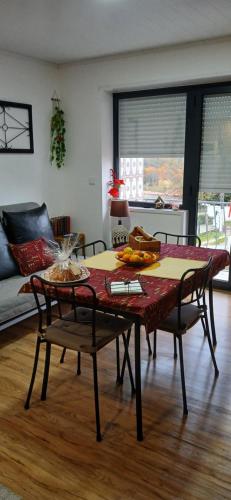 a living room with a table and chairs and a couch at Casa da Aldeia in Figueiró dos Vinhos