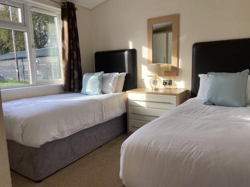 Field View 2 bed-No pets-Hornbeam في Horham: غرفة نوم بها سريرين ونافذة