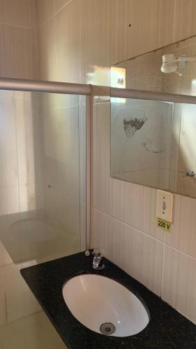 a bathroom with a sink and a shower at JR POUSADA in Morro do Chapéu