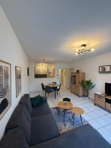 a living room with a couch and a table at Moselzeit - Moderne Ferienwohnung mit Terrasse und Burgblick in Bernkastel-Kues