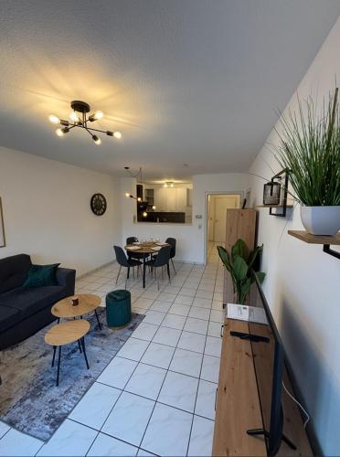 a living room with a couch and a table at Moselzeit - Moderne Ferienwohnung mit Terrasse und Burgblick in Bernkastel-Kues