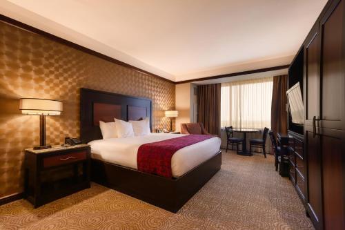 a hotel room with a bed and a television at Downstream Casino Resort in Loma Linda