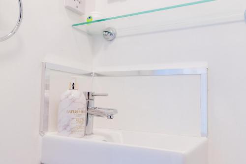 a white bathroom with a sink and a mirror at New Street C - City Centre in Worcester