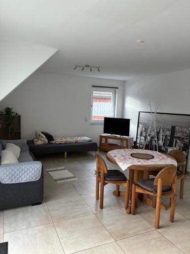 a living room with a table and a couch at MP Apartments in Hückelhoven