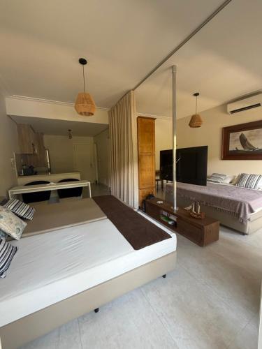 Кровать или кровати в номере Residências Garcez - Pantai Enseada - Vista Mar