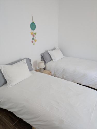 two beds sitting next to each other in a bedroom at Casas da Lola - Mourão in Mourão