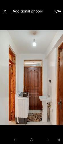 a bathroom with a bath tub and a sink at 2bedroom house along waiyaki way in Nairobi