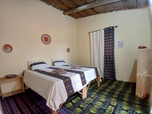 Ένα ή περισσότερα κρεβάτια σε δωμάτιο στο Lompoul Nature