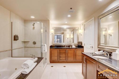 a large bathroom with a tub and a sink at MGM Signature-09-821 1Br2Ba F1 Strip View Balcony Suite in Las Vegas