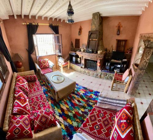 an aerial view of a living room with a fireplace at lake view, comfortable artistic design in Ouirgane