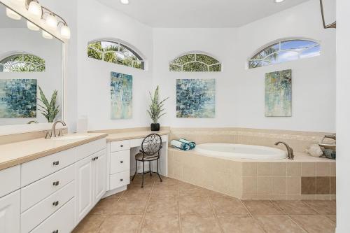 a bathroom with a tub and a sink at Coastal River Oasis in Cape Coral