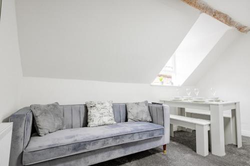 a living room with a couch and a table at 2 Bedrooms - New Street - Sleeps 4 in Worcester