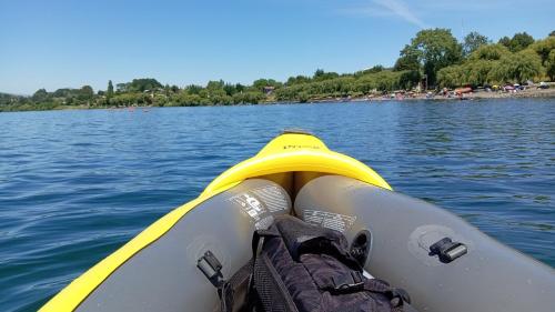 a view of the front of a kayak on a lake at entrre lagos Departamento in Puyehue
