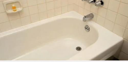 a white bath tub with a faucet in a bathroom at Evo Yellow Gravesend 2 bed Apartment - 2 mins STN Town Centre in Gravesend