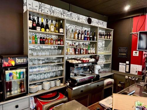 a restaurant with a counter with bottles of alcohol at Ibis Katowice - Zabrze in Zabrze