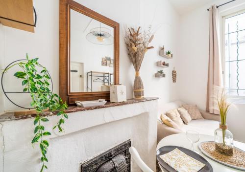 Studio mezzanine cosy au centre Beaucaire - Cocon 2 في بوكير: غرفة معيشة مع موقد ومرآة