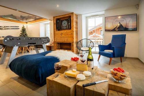 a bedroom with a bed and a table with wine glasses at Le Refuge de Lucien - OVO Network in Gérardmer