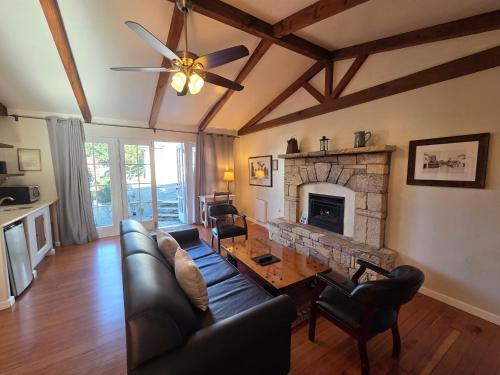 a living room with a table and a fireplace at Forest Lodge in Carmel
