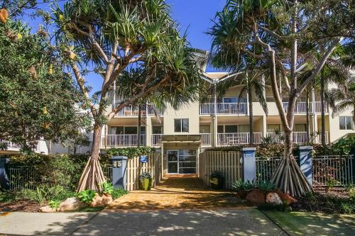 ペレジアンビーチにあるHorizons At Peregianの前にヤシの木がある建物