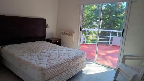 a bedroom with a bed and a door to a balcony at Okin 22 La Reserva in Costa del Este