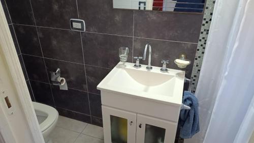 a bathroom with a sink and a toilet at Okin 22 La Reserva in Costa del Este
