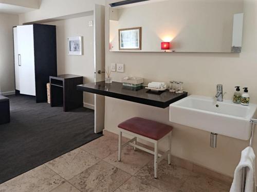 baño con lavabo y encimera con fregadero en Cape Town CBD Pool Near CTICC Parliament Waterfront, en Ciudad del Cabo