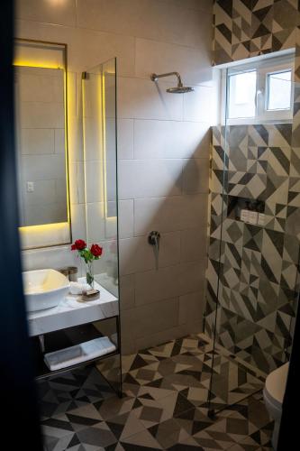 a bathroom with a sink and a shower at Olivar House Hotel in Lima