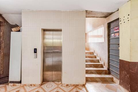 a hallway with a door and stairs in a building at 2bedroom house along waiyaki way in Nairobi