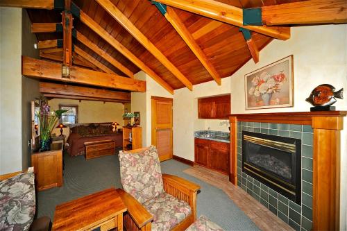 a living room with a fireplace and a couch at Elk Cove Inn & Spa in Elk