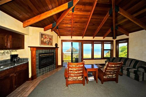 a living room with a couch and a fireplace at Elk Cove Inn & Spa in Elk