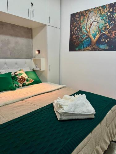 a bedroom with two beds with towels on the bed at Pousada Residencial A Dantas in Búzios