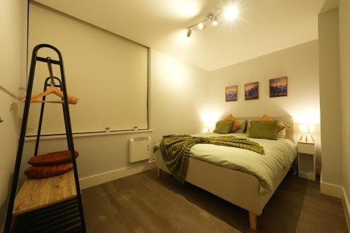 a bedroom with a bed and a ladder in it at Modern & Cozy Flat in the Heart of Chelmsford - F7 in Chelmsford