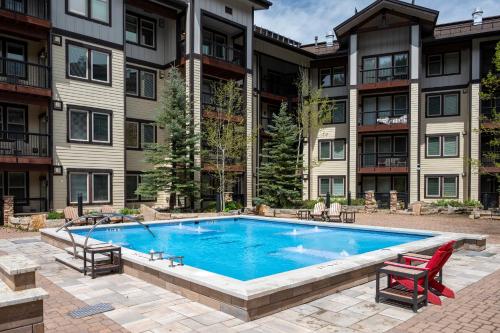 a swimming pool in front of a apartment building at Ski-In / Ski-Out 1 Bedroom Condo base of WP Resort in Winter Park