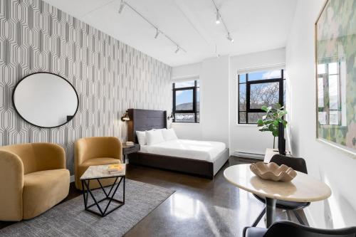 a living room with a bed and a table at The Cove Hotel - Plateau Mont-Royal in Montreal